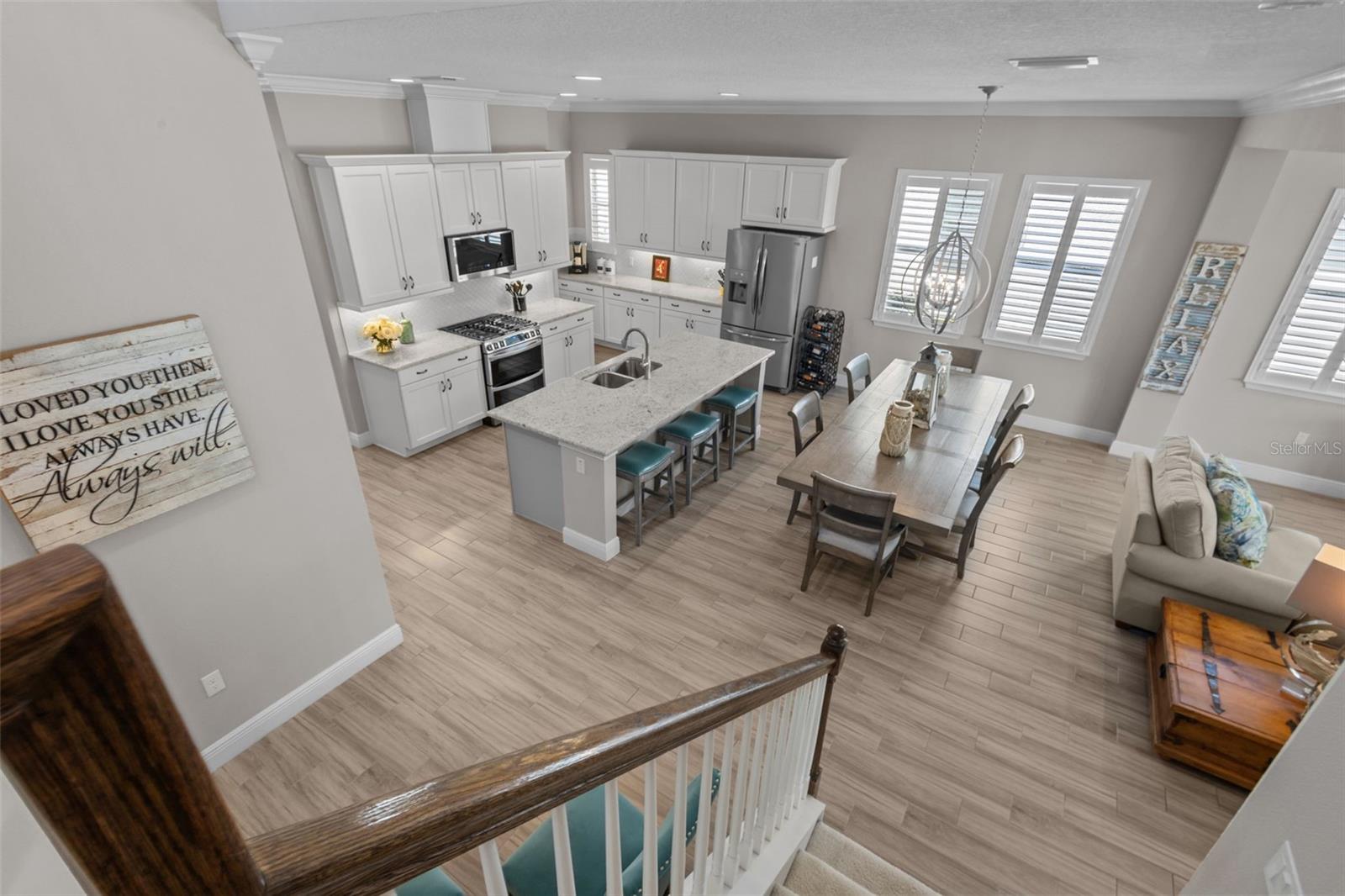 View of dining/kitchen/living from stairs