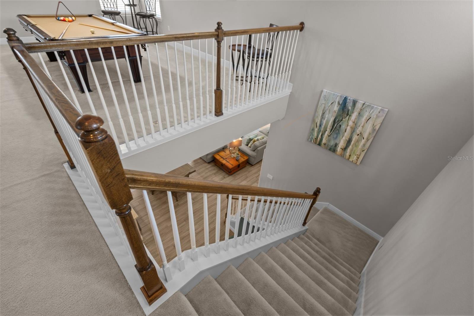 View of dining/kitchen/living from stairs