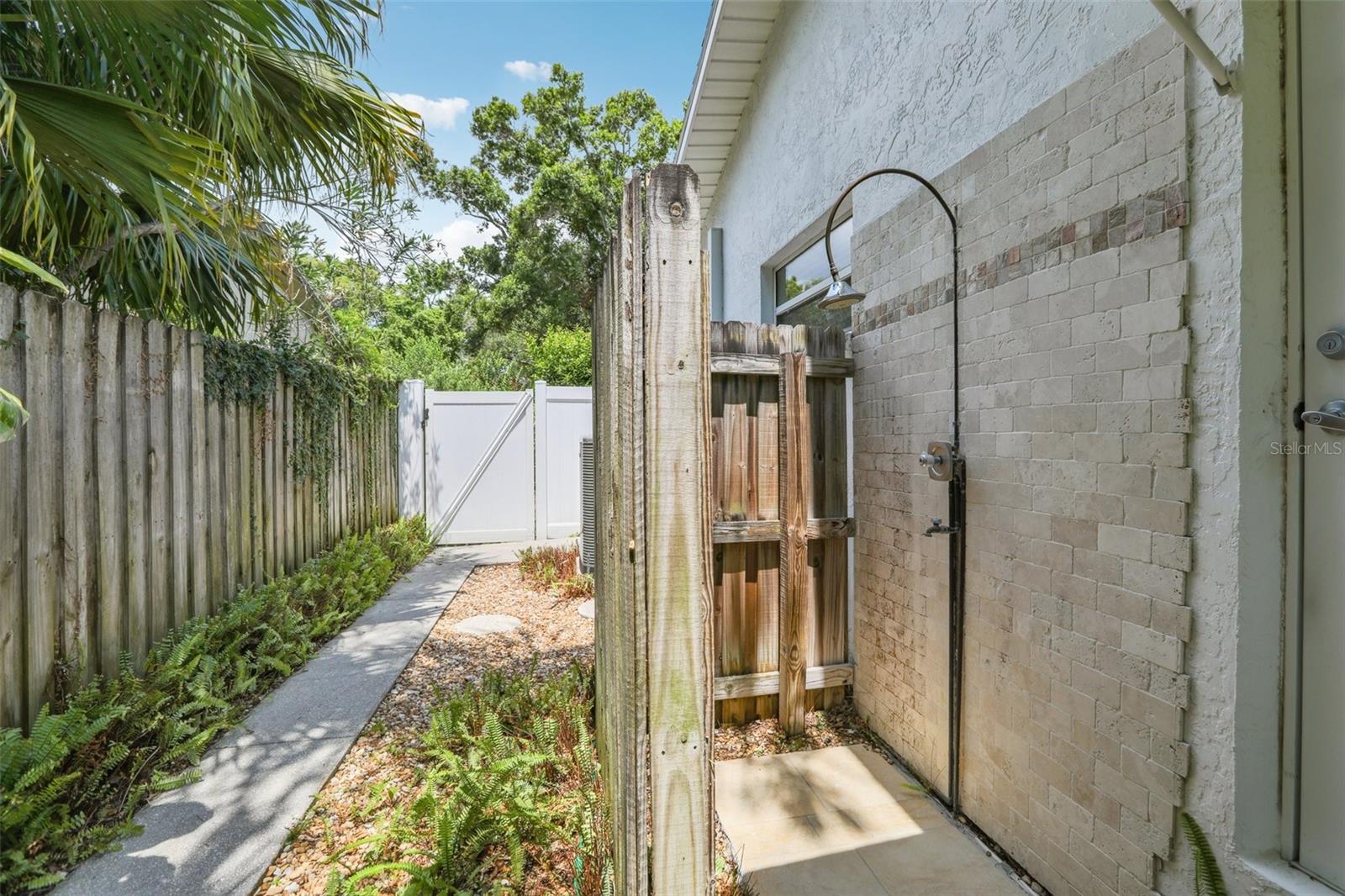 outdoor shower with hot and cold water and door to full bathroom
