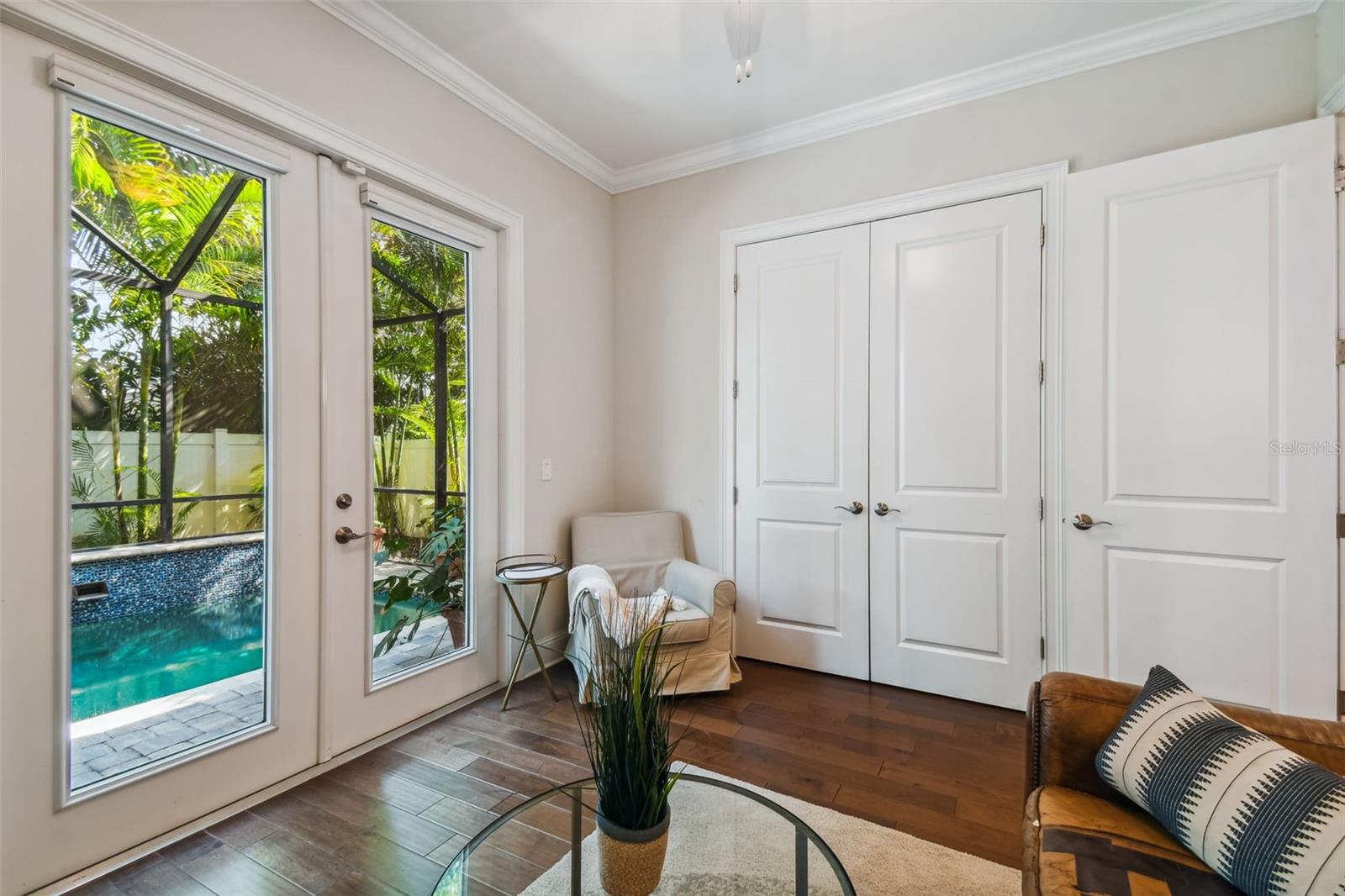 Guest bedroom with exterior access and closet with custom shelving