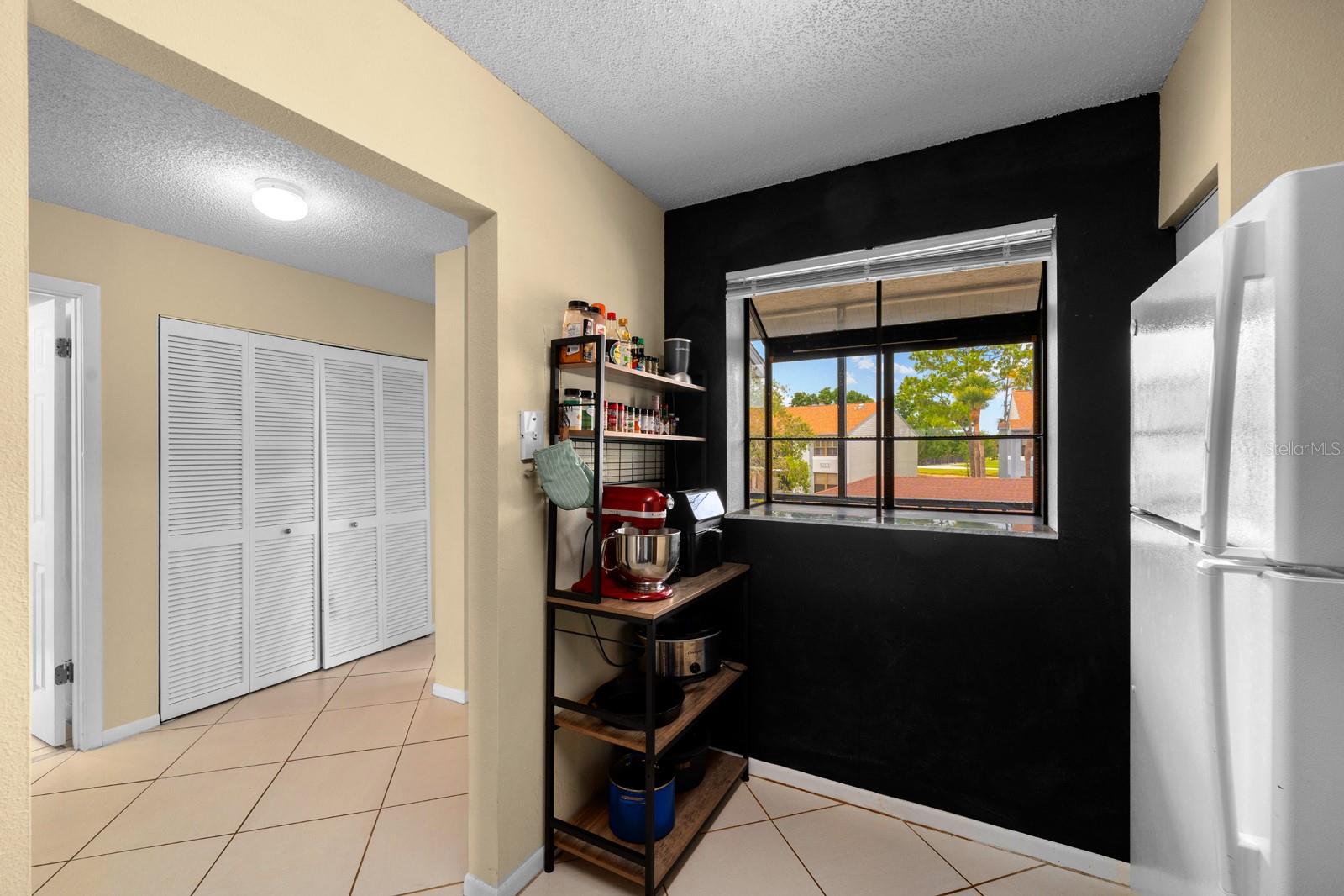 Kitchen has a window box overlooking the screen enclosed porch