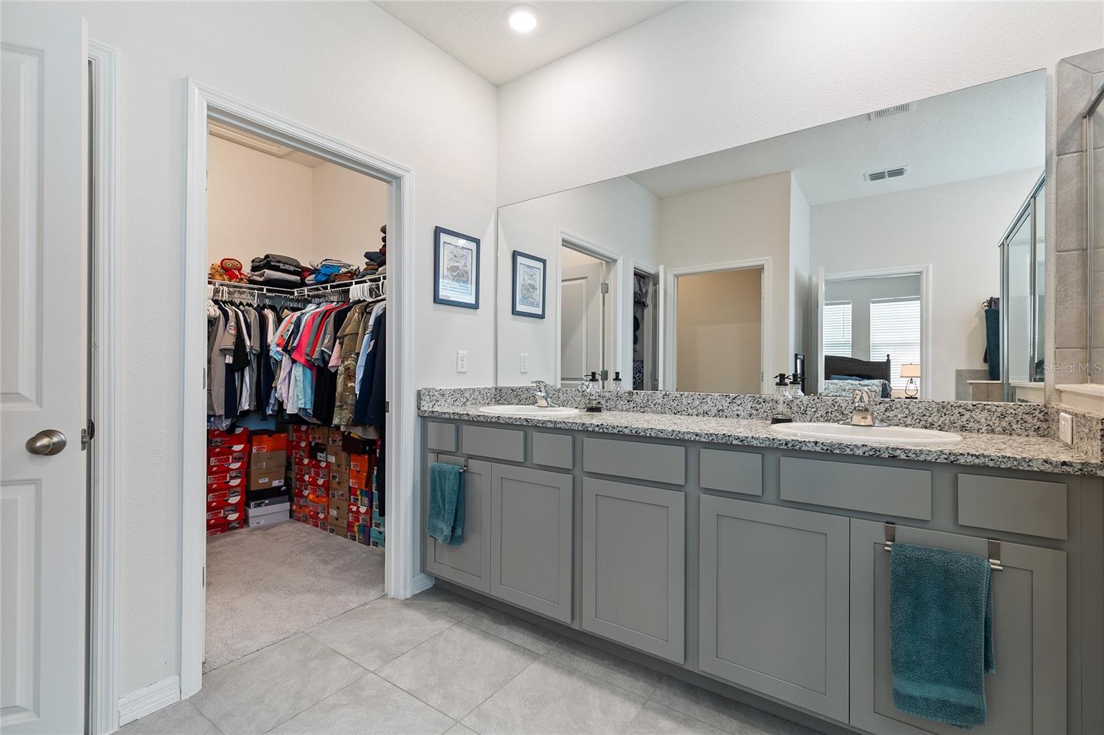 Dual granite vanity with walk in closet.