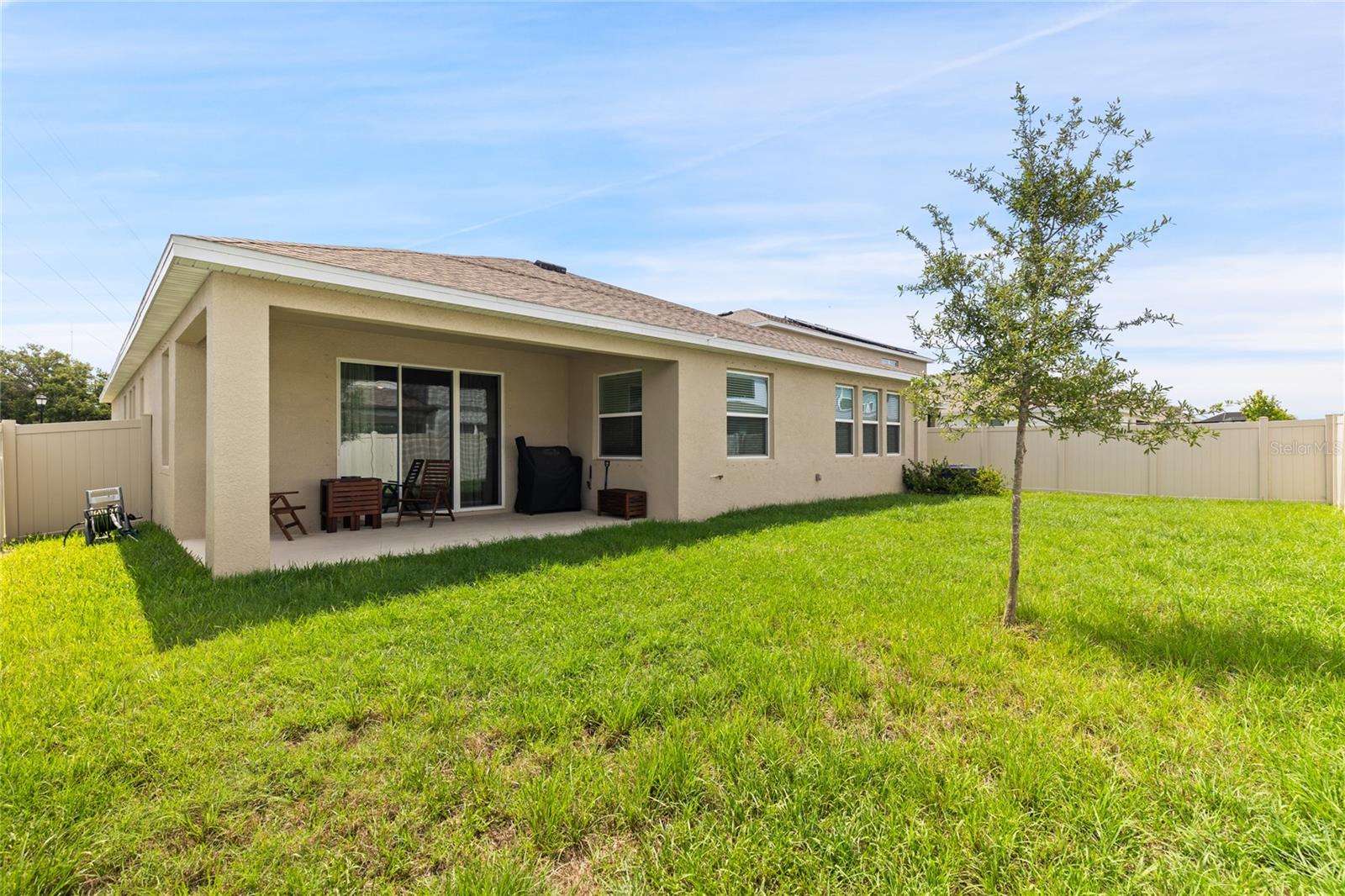 The fully fenced backyard provides a safe, secure space for kids and pets to play, while the covered patio is perfect for family gatherings and weekend barbecues."