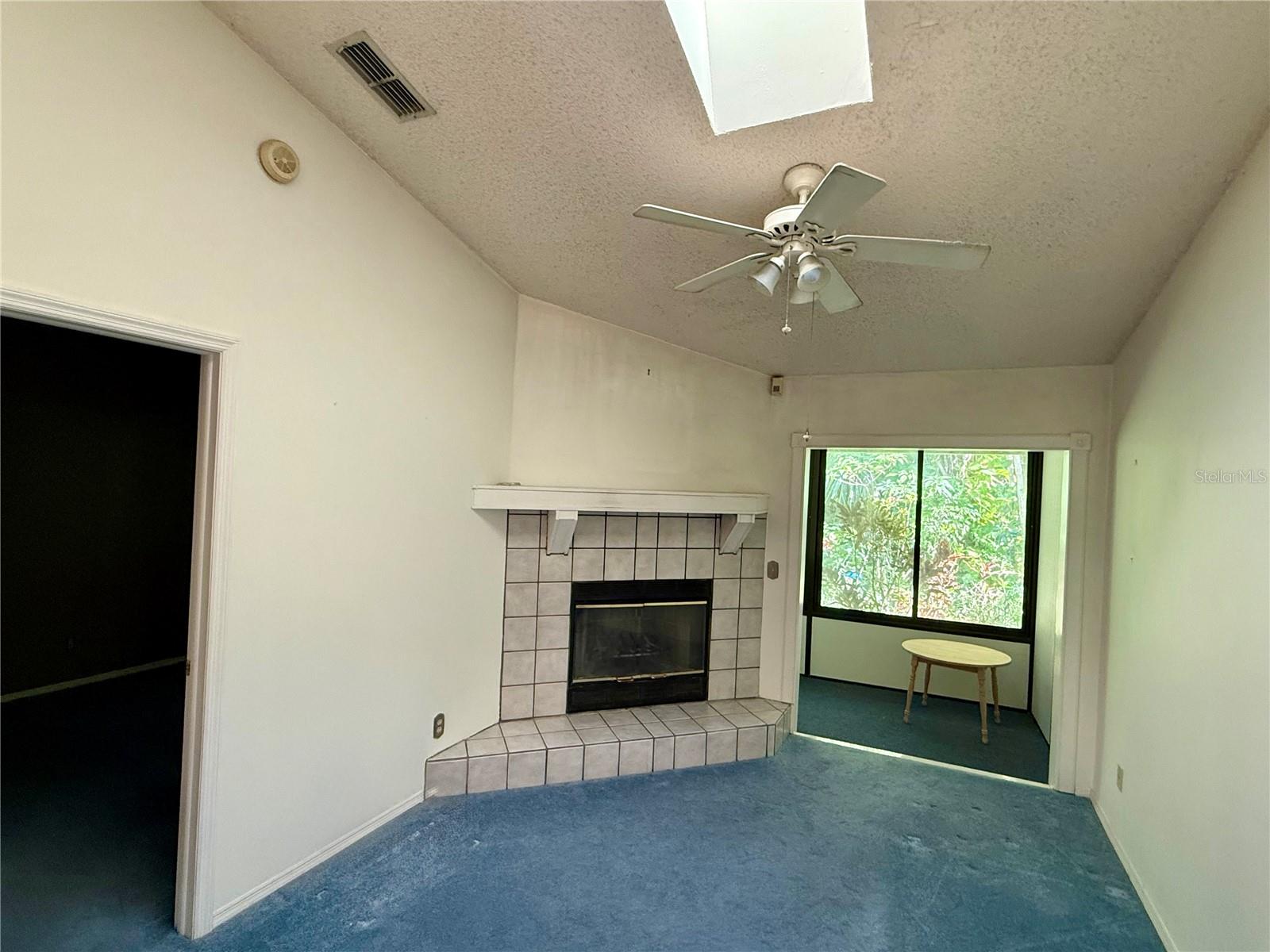 The great room has vaulted ceilings and a cozy corner fireplace.