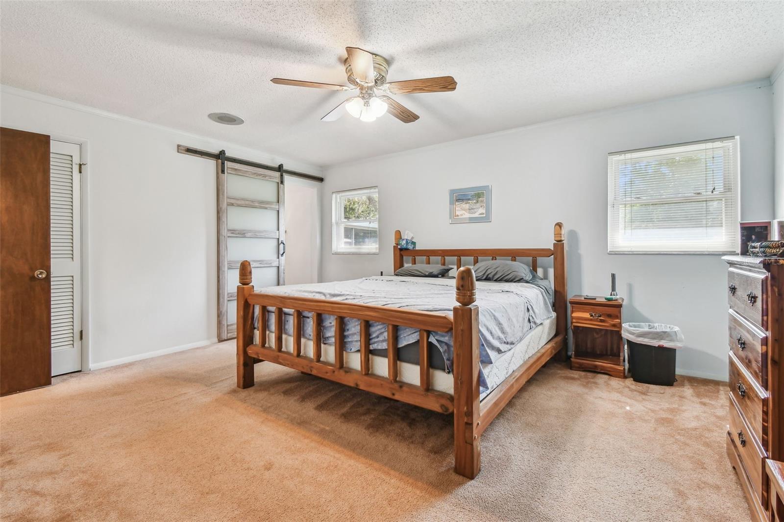 Primary Bedroom w/Barn Door to Primary Bathroom