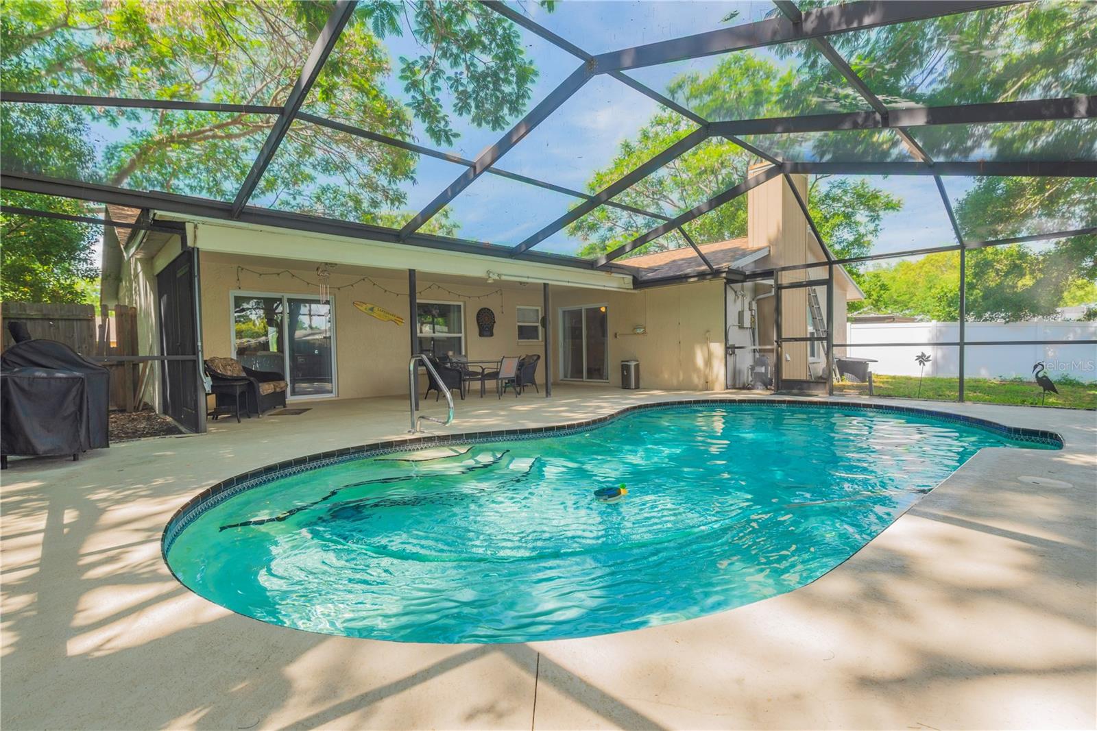 In ground pool with screened lanai.