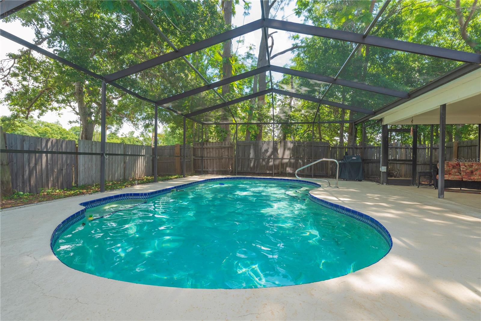 In ground pool with screened lanai.
