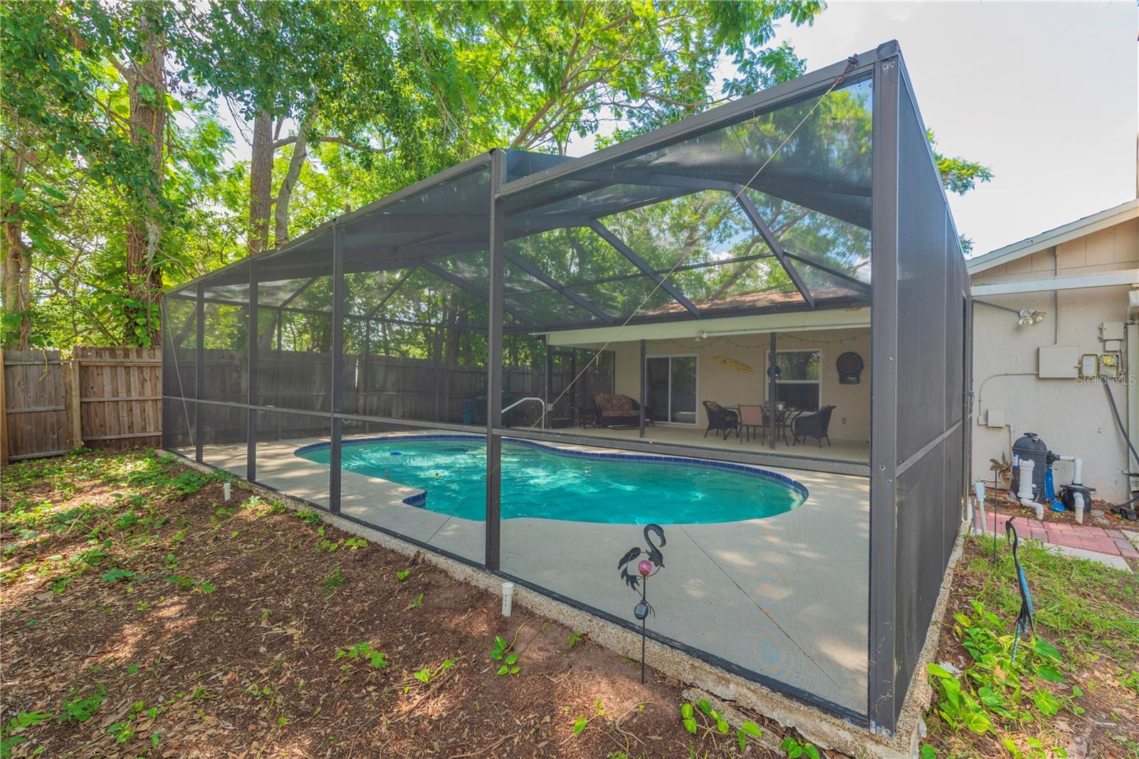 In ground pool with screened lanai.