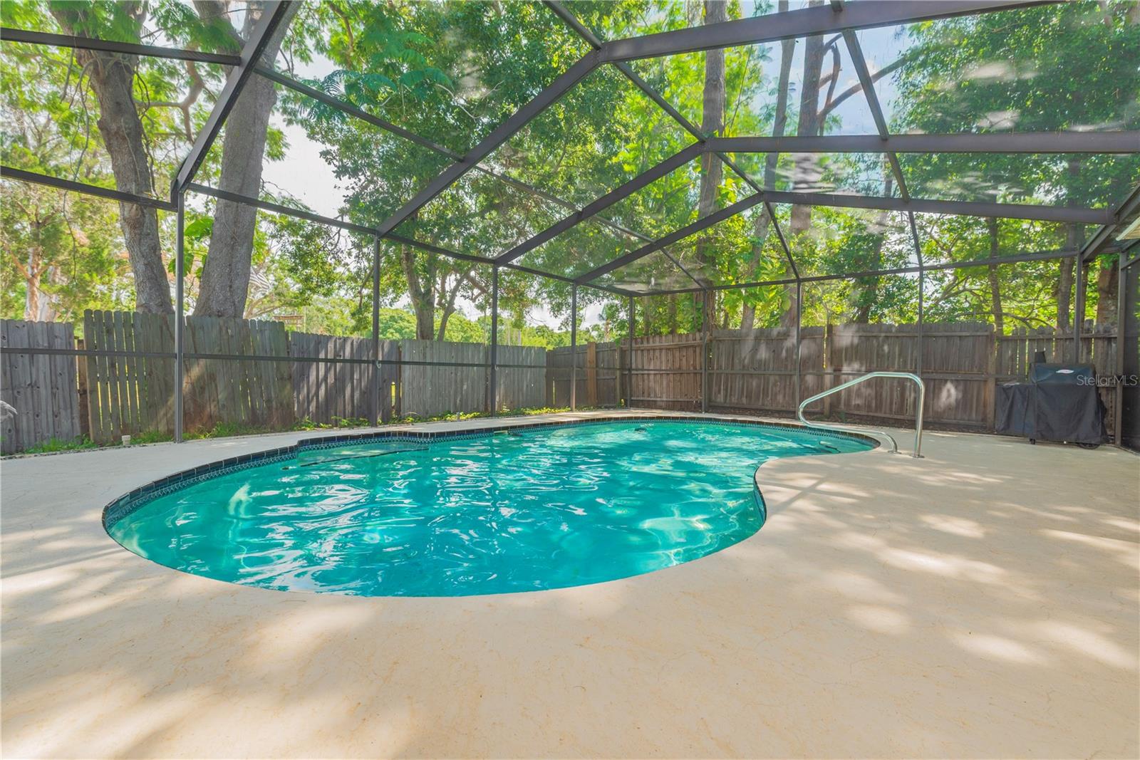 In ground pool with screened lanai.