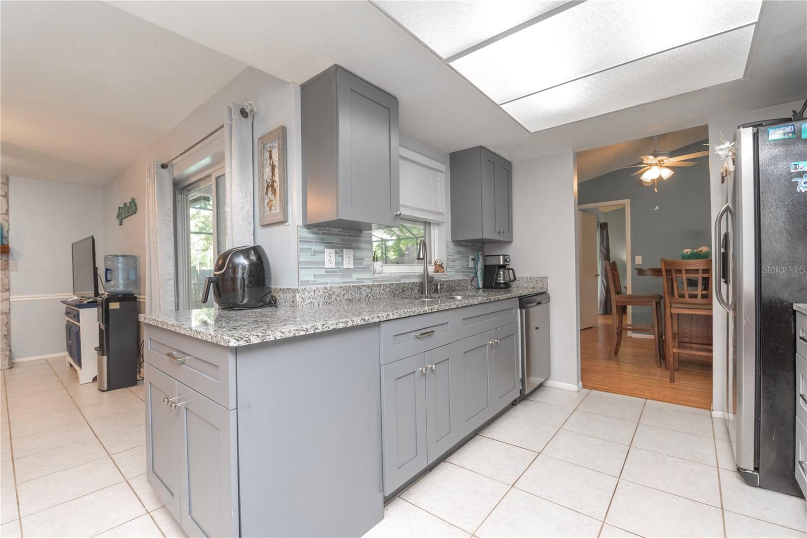 Kitchen with granite counter tops and modern cabinets.