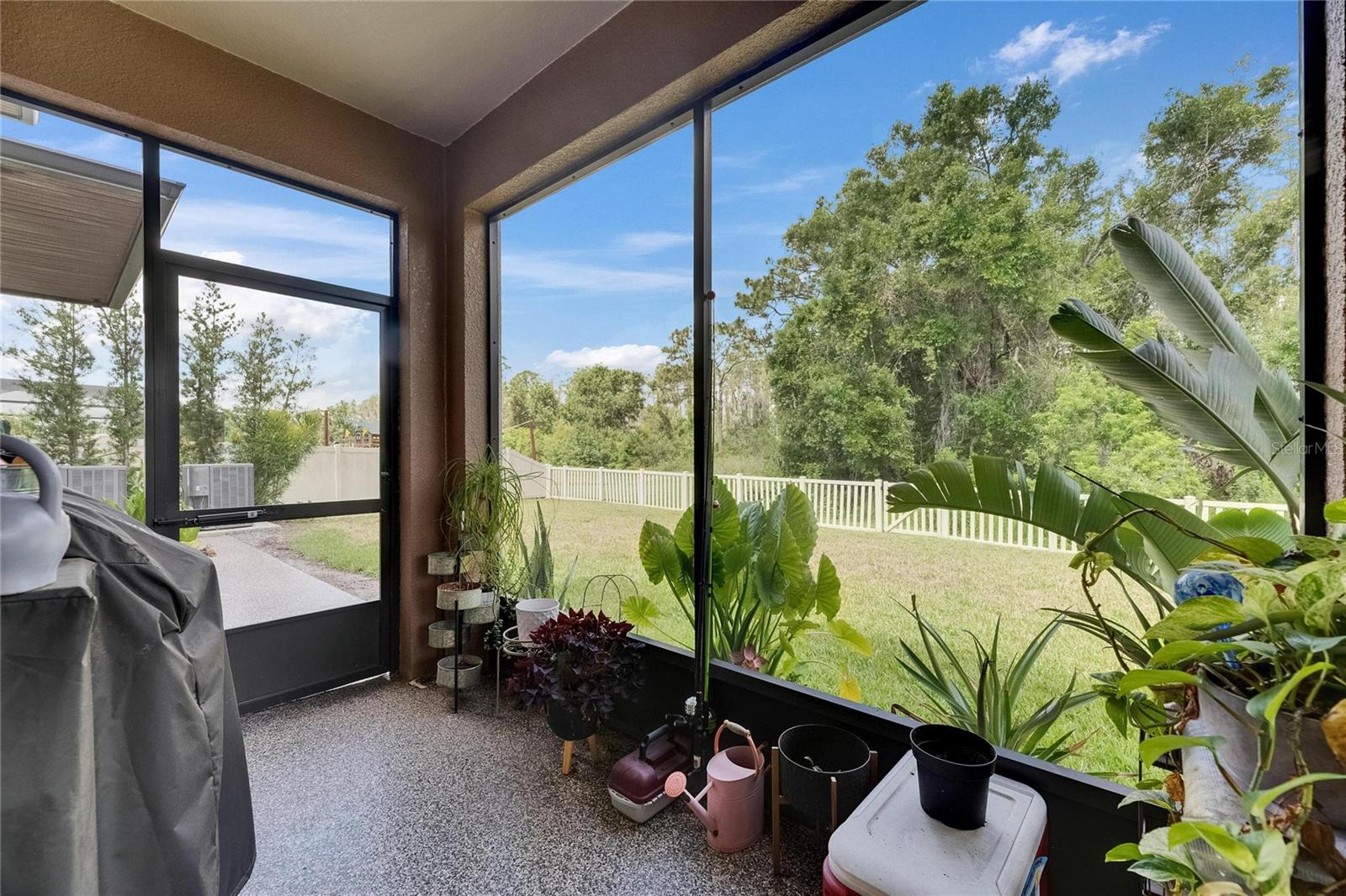 Enjoy a snack in the kitchen or step outside to the screened-in lanai, where you can relax in privacy with peaceful conservation views in the fully fenced backyard.