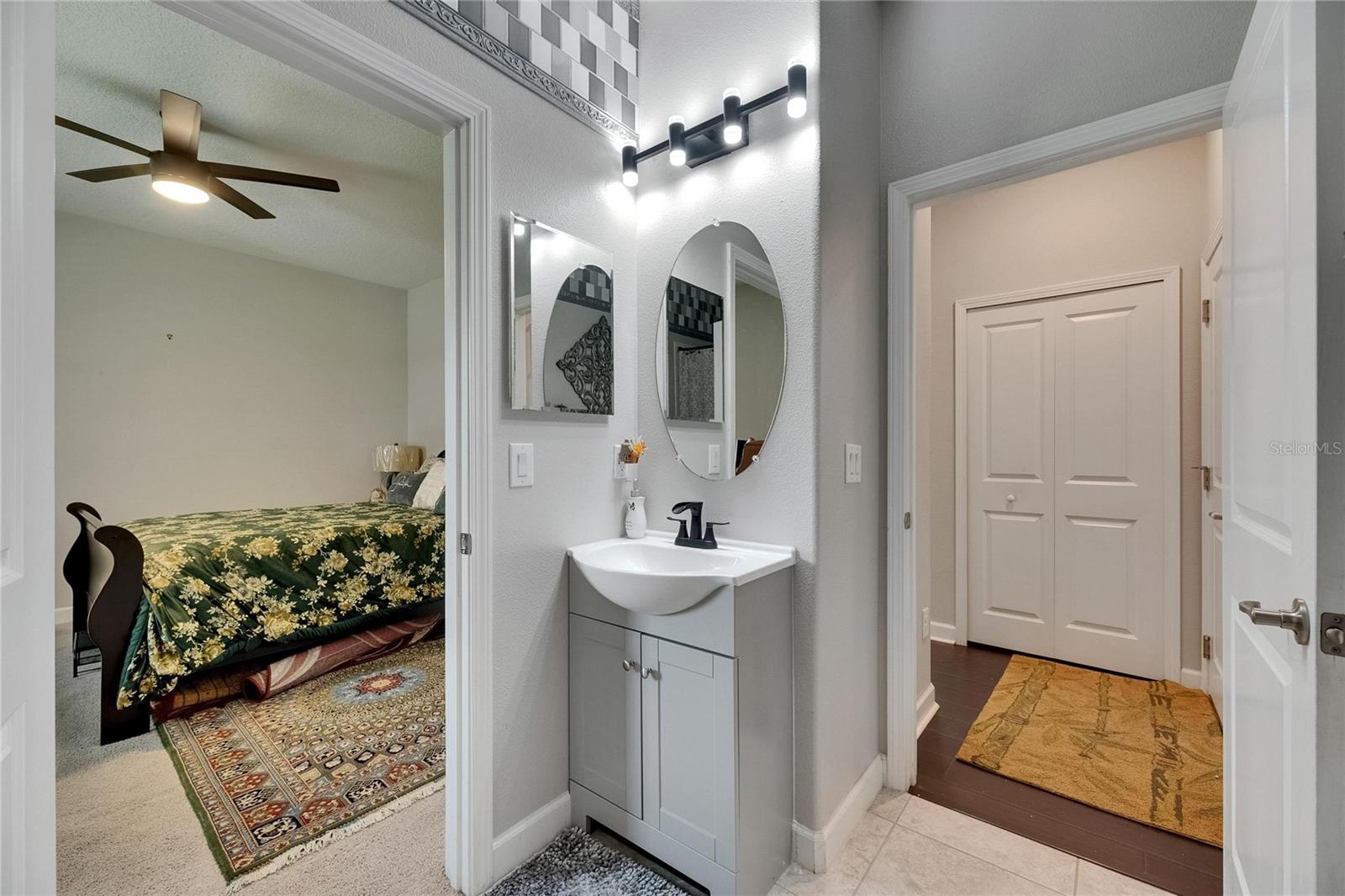 hall bath features updated LED lighting fixtures and stylish cabinetry