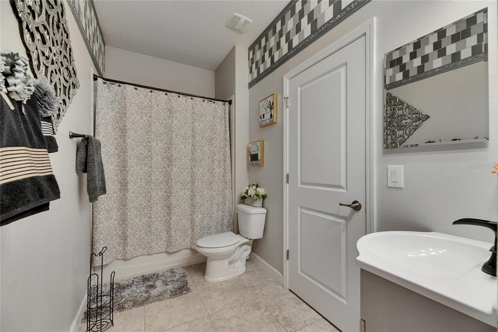 The first-floor hall bath is elegantly designed and includes a full bath/shower combination, perfect for guests or multi-generational living.