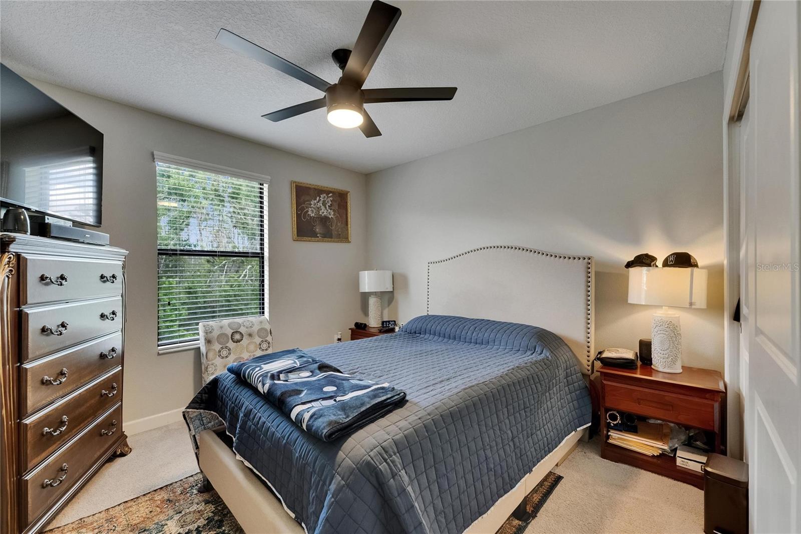 nice size secondary bedroom with outdoor views and celling fan