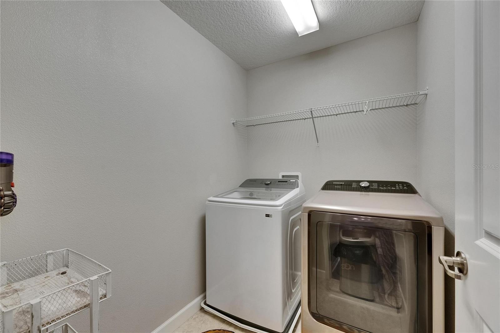The laundry room is conveniently located near the secondary bedrooms, making everyday chores more efficient and accessible