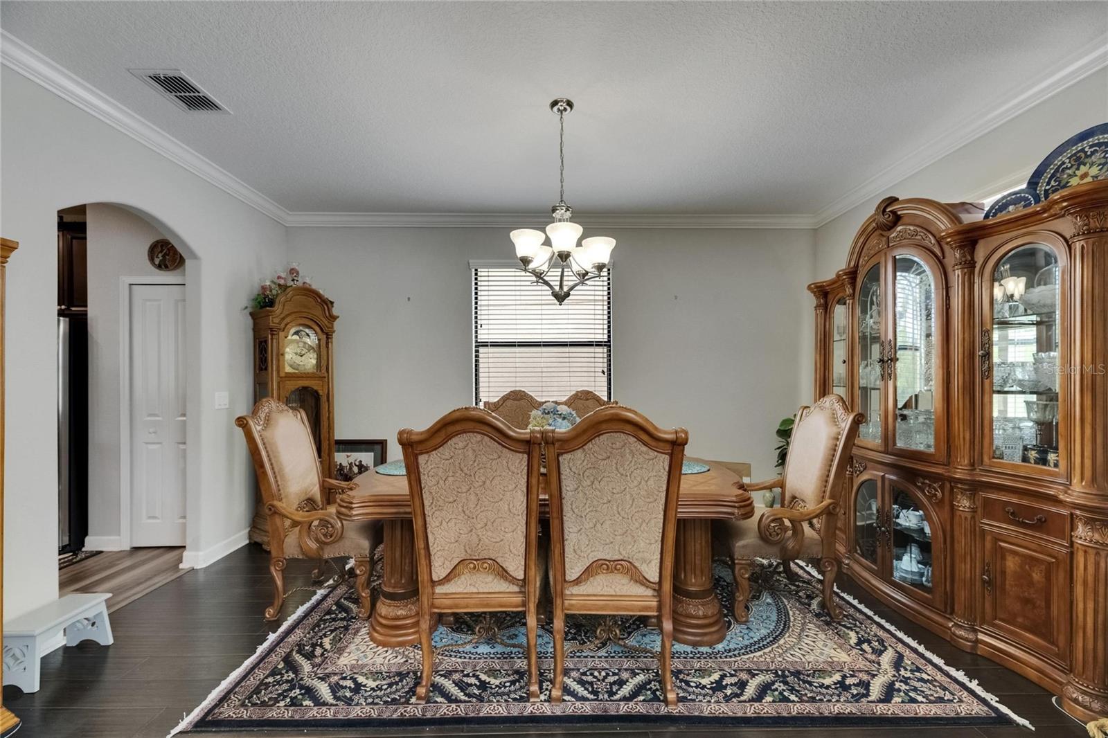 The formal dining room is spacious enough to accommodate the largest of gatherings, perfect for hosting memorable dinners and celebrations with easy access to the kitchen.