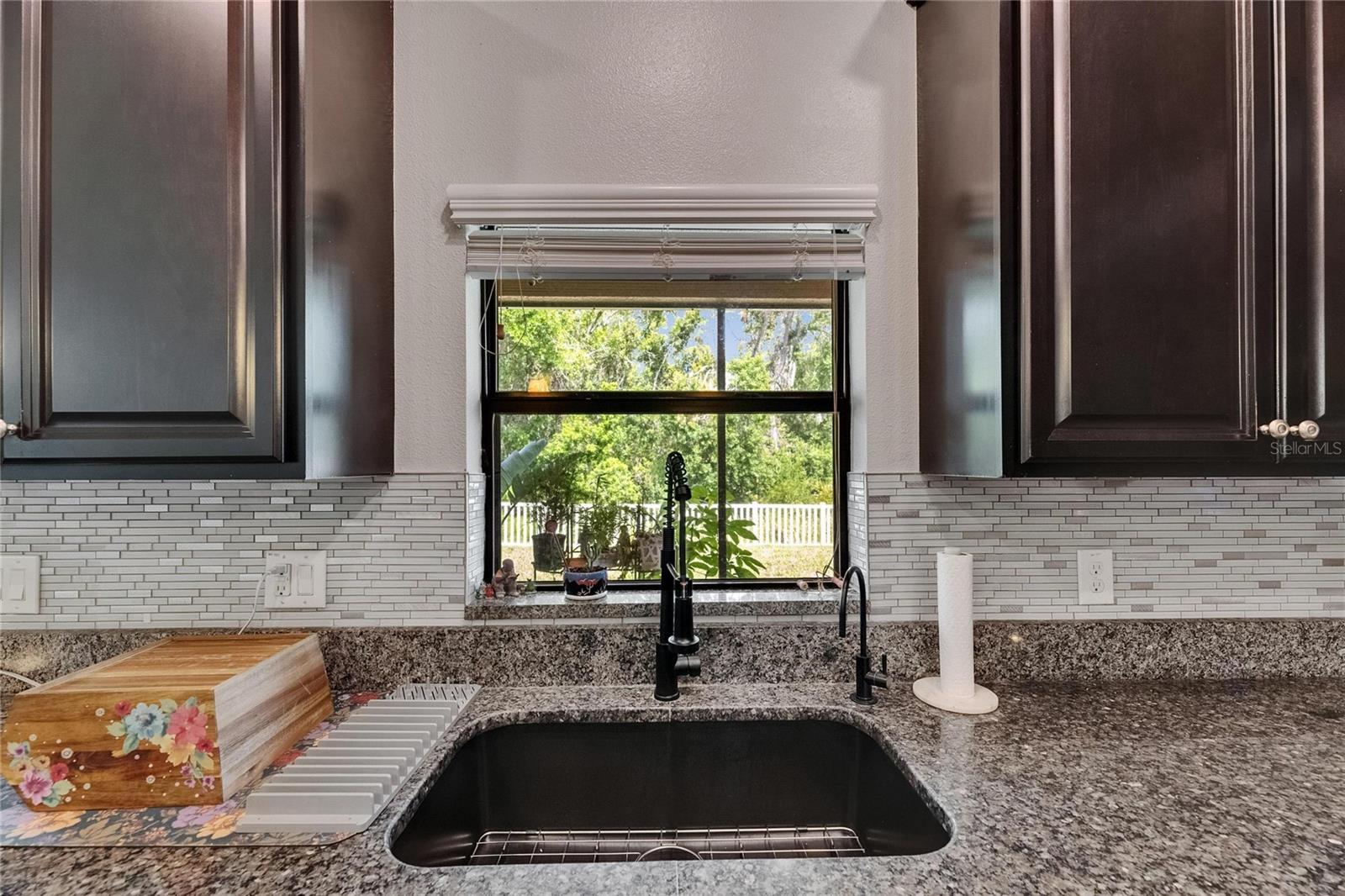 Let the natural light pour in through the kitchen window, perfectly framing peaceful conservation views and enhancing the warmth of the space.