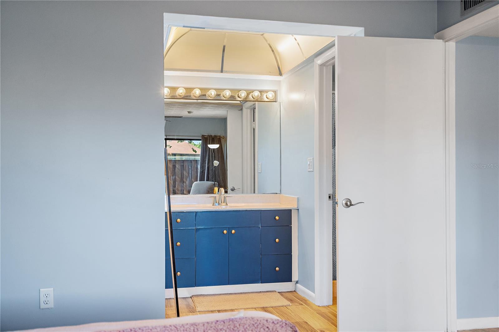 En suite bathroom with separate vanity area and walk in closet