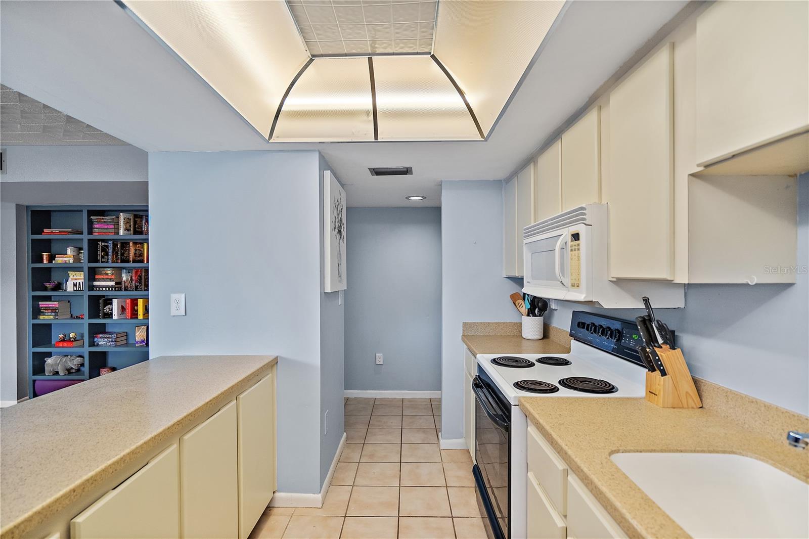 Kitchen is open to living area with breakfast bar