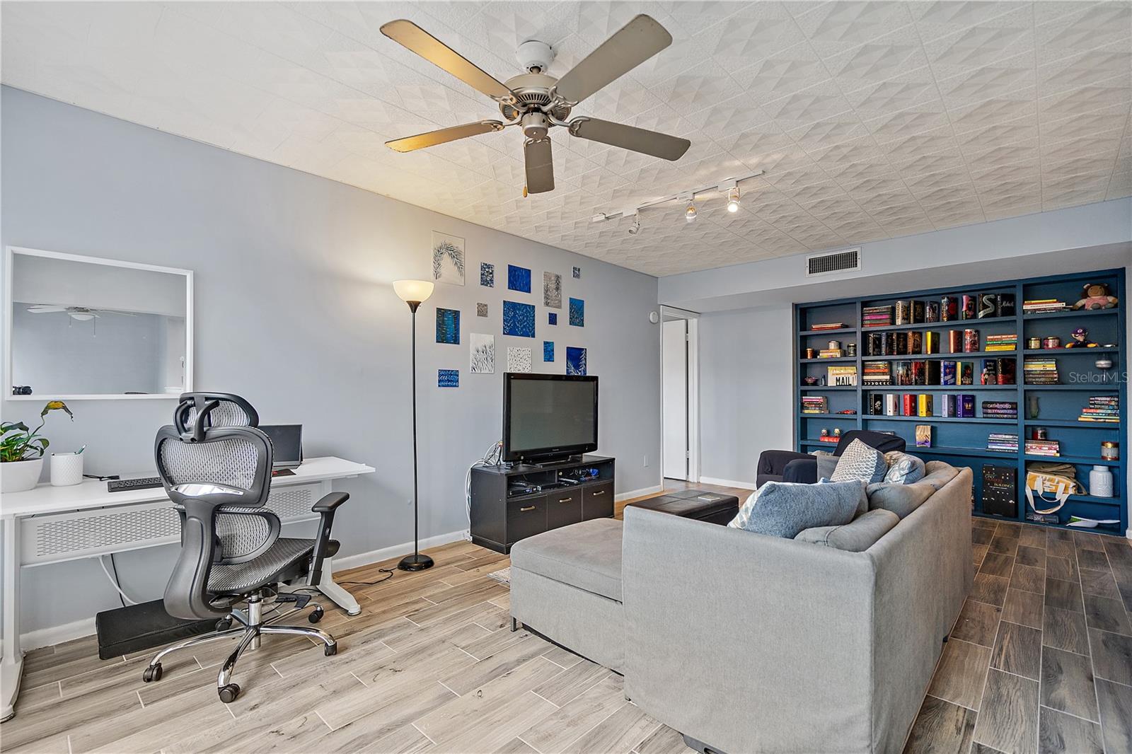 Plenty of space in the living room featuring a large built in bookcase