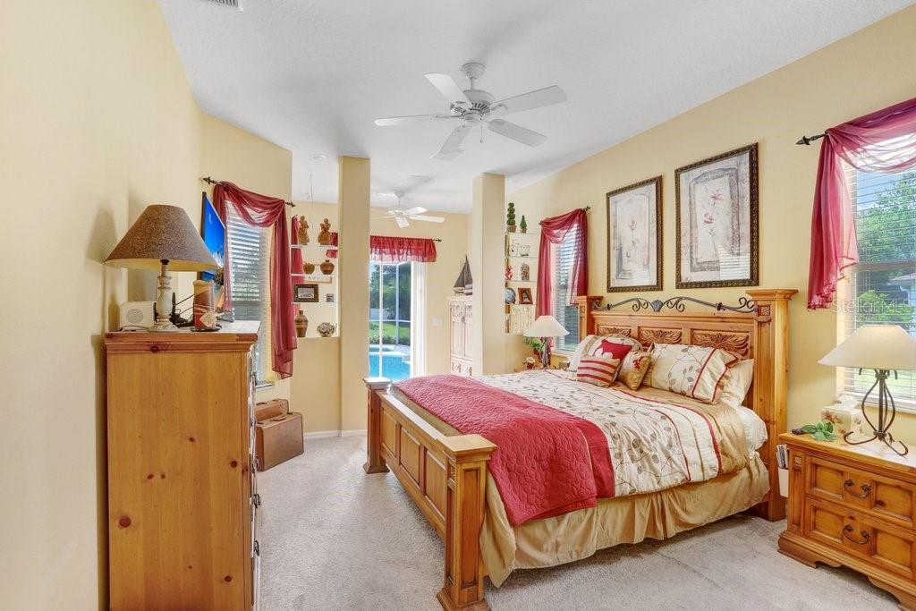 Large master bedroom with built-in cabinets & natural light