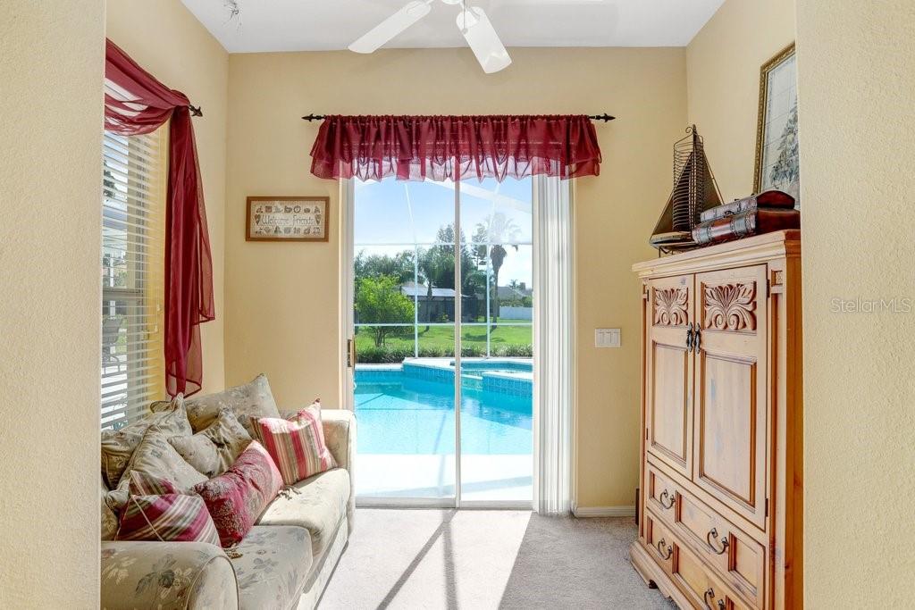 Master bedroom separate sitting room with sliding doors to the pool deck