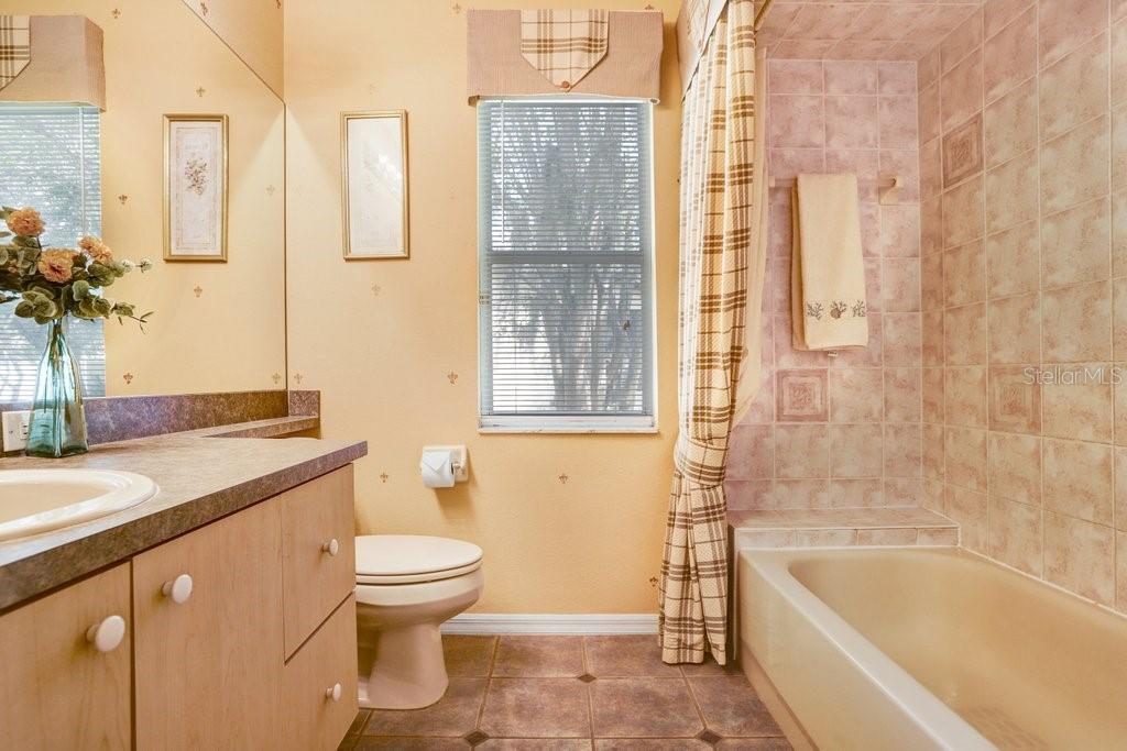 Bathroom in hallway between the two bedrooms and built-in study desk