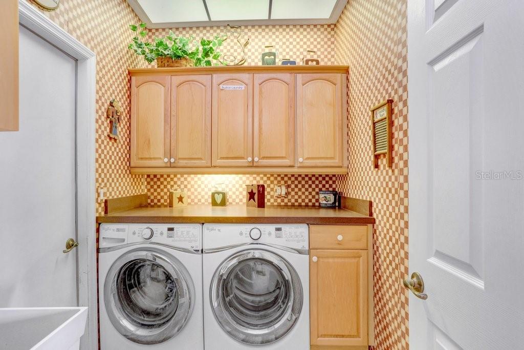 laundry room with utility sink conveniently located at the garage entrance to the kitchen