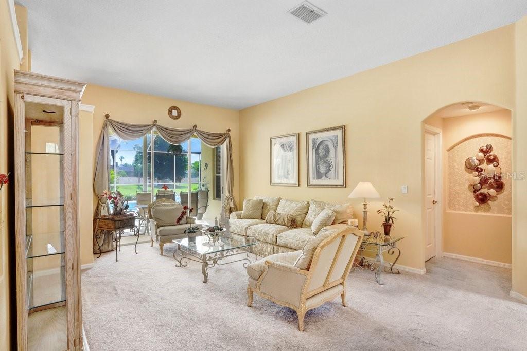 Formal living room with sliding doors to the pool deck