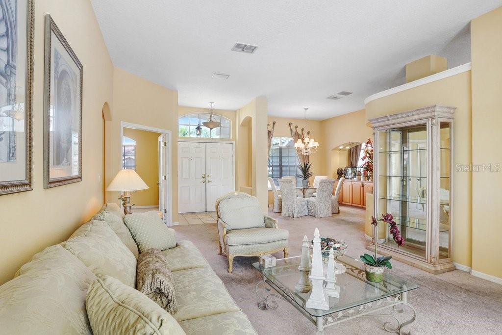 Formal living room view of entry and dining room