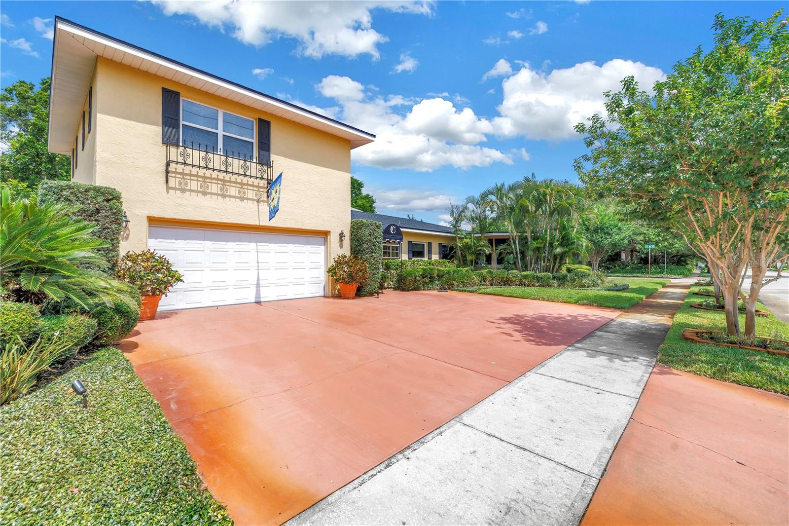 Two car garage and parking pad.