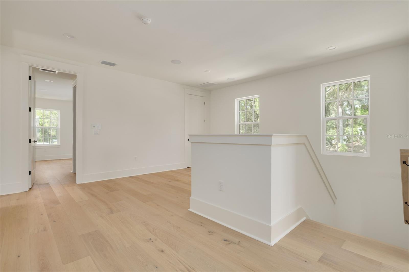 Loft separates the upstairs bedrooms and creates a versatile space for any needs. This photo is a different model, similar finishes will be provided.