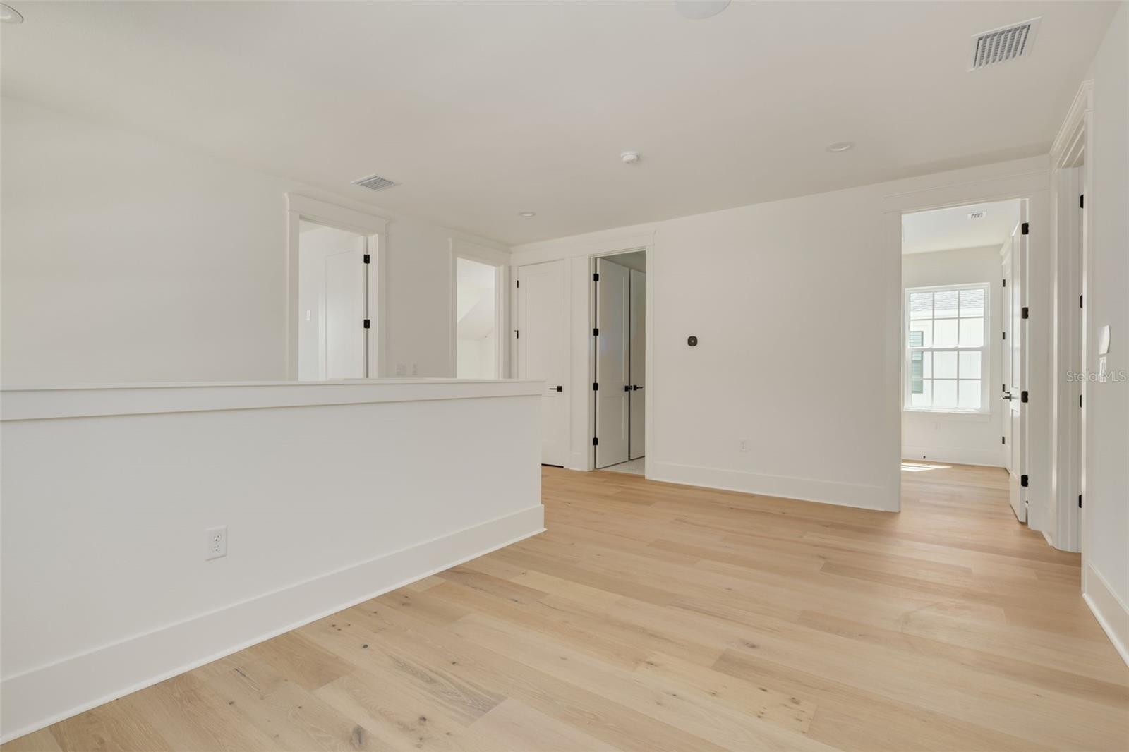 Loft separates the upstairs bedrooms and creates a versatile space for any needs. This photo is a different model, similar finishes will be provided.