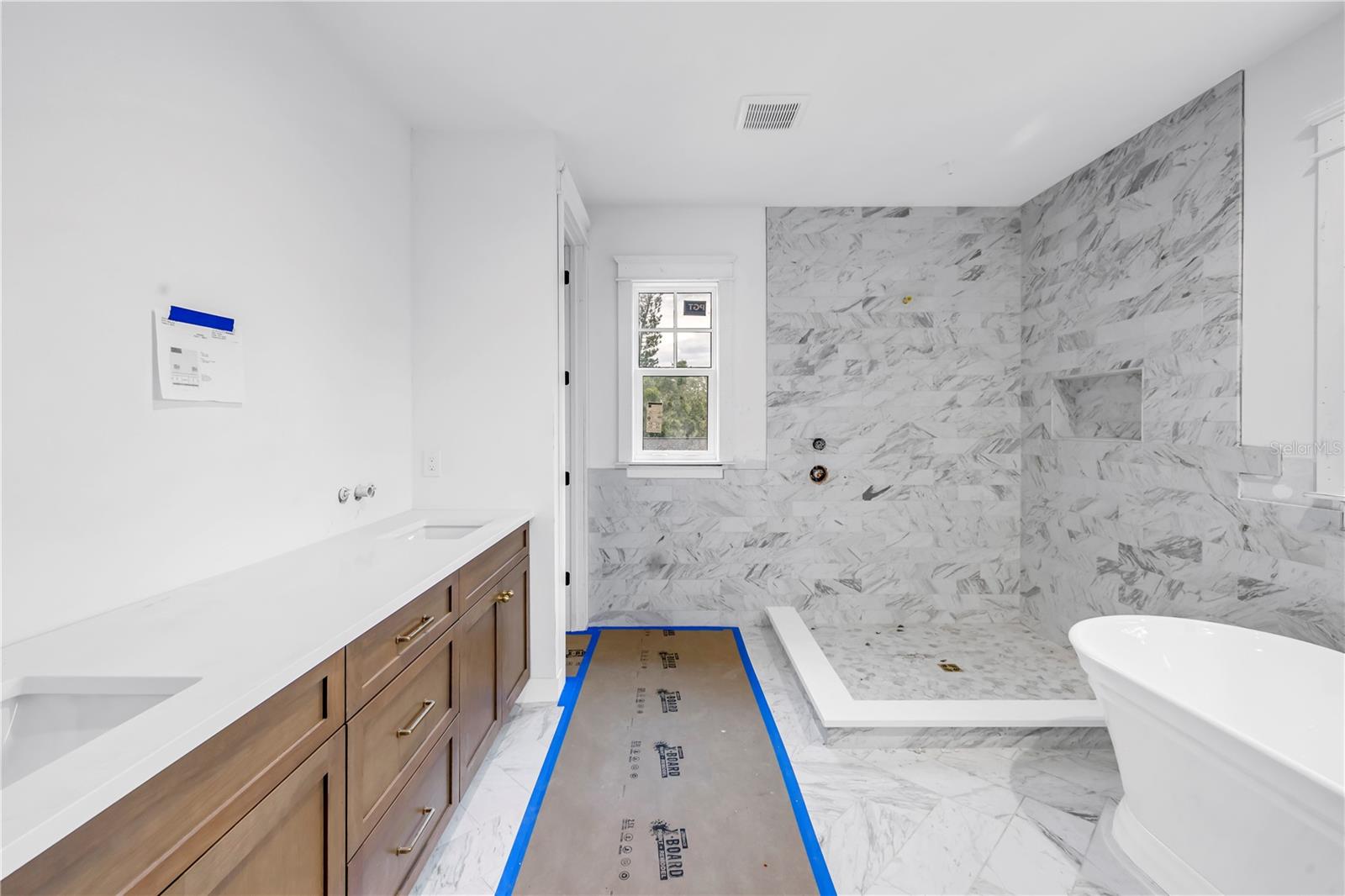 The main bath exudes luxury with marble finishes throughout