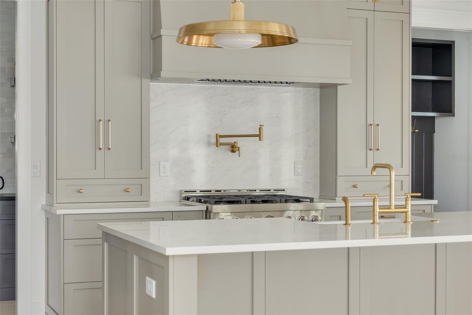 Representative kitchen design - solid wood shaker 42" cabinets with top stack to ceiling, 36" base cabinets upgraded hardware and soft close drawers & doors, 6" Cove Crown Kitchen Cabinet Moulding, Upgraded Level Quartz (3cm) Kitchen Countertops, KitchenAid (or equal) stainless steel appliance package. This photo is a different model, similar finishes will be provided.