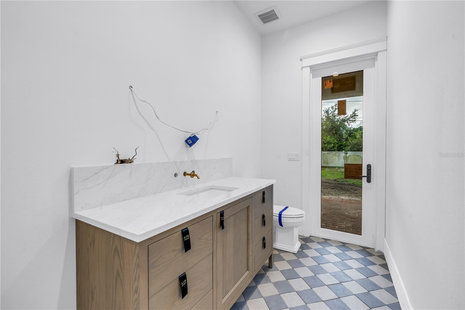 Powder bath in - leads to the outdoor patio perfect for a pool bath