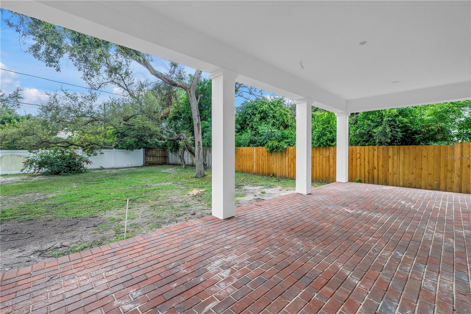 Rear patio overlooking the spacious backyard