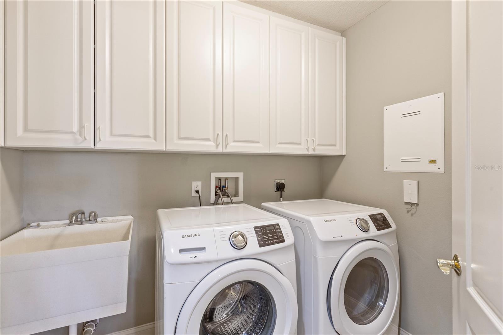 A full-sized laundry with lots of storage and a coveted wash sink.