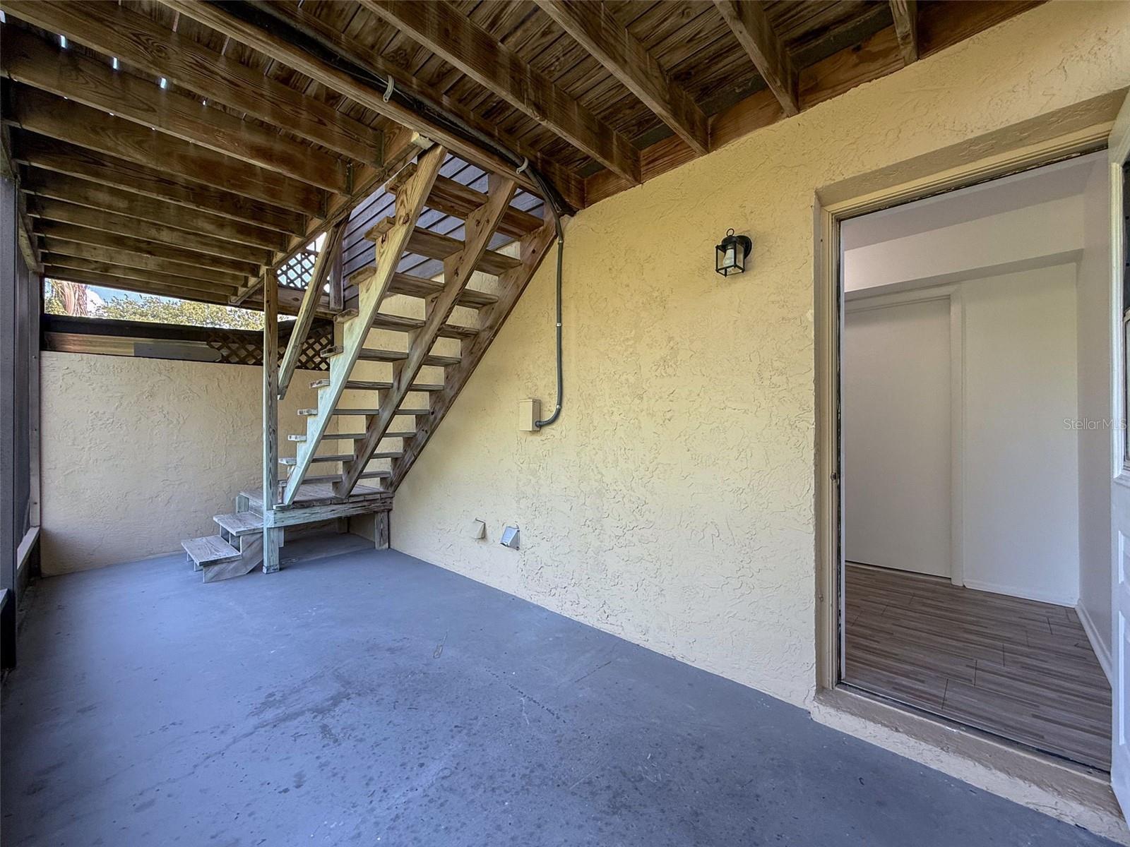 Downstairs patio with entrance to the laundry room and garage
