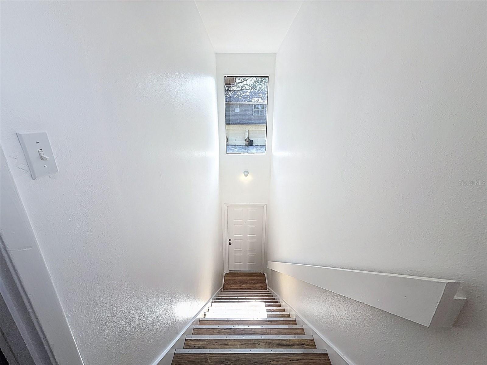 View of the front door from the top of the stairs