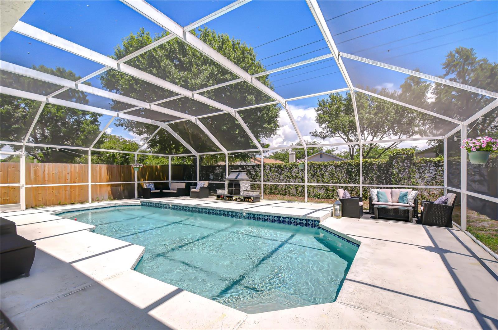 The fenced yard offers privacy, while a pineapple garden, lime-producing bushes, and a young Meyer lemon tree add a tropical touch!