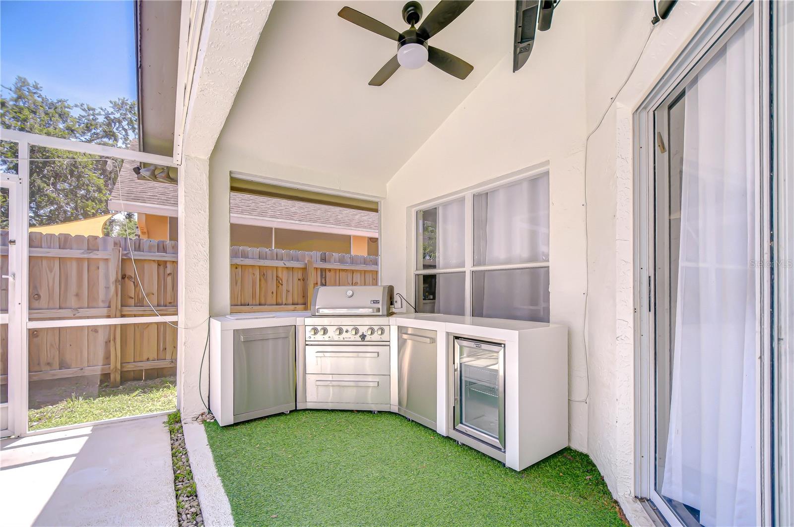 Summer is here and this home has a custom outdoor kitchen complete with grill, fridge, and storage!