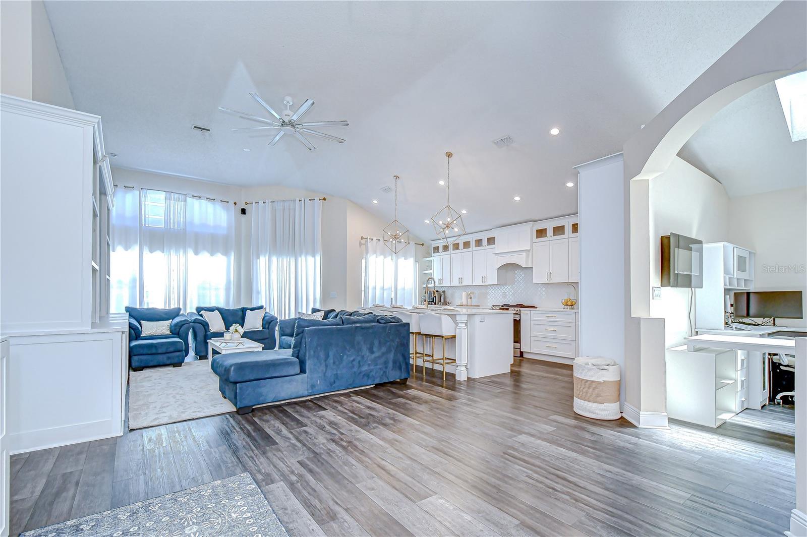 Inside, you'll find soaring 12-foot ceilings, luxury vinyl plank flooring throughout the main areas (2022), and a bright, open-concept layout that’s as functional as it is beautiful!
