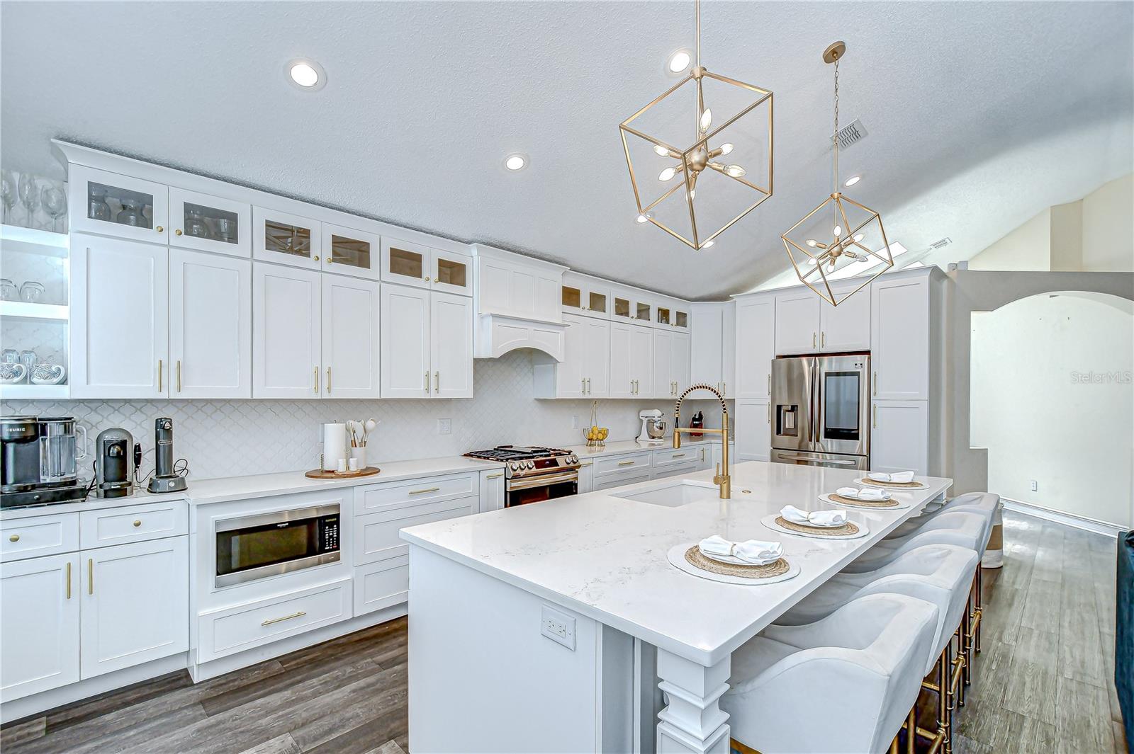The kitchen is fully remodeled with custom Fabuwood cabinetry and a massive quartz island!