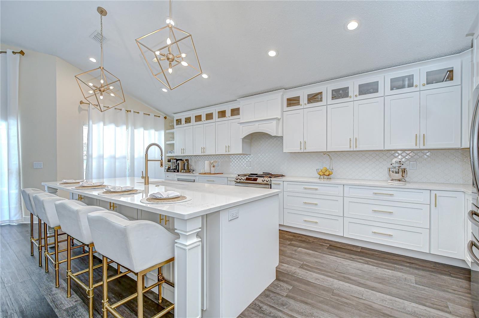Enjoy a Samsung refrigerator, and stainless appliances including a flat-top range with built-in air fryer, wine fridge, microwave, and dishwasher replaced in 2021!