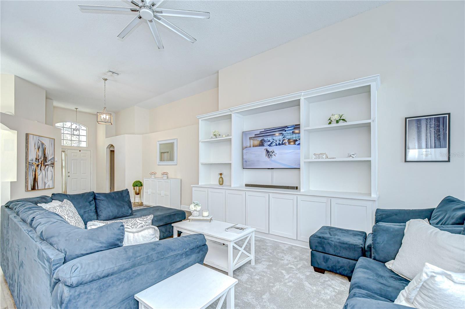 The living room includes custom, hand-made built-in shelving and storage (2023), adding both charm and functionality!