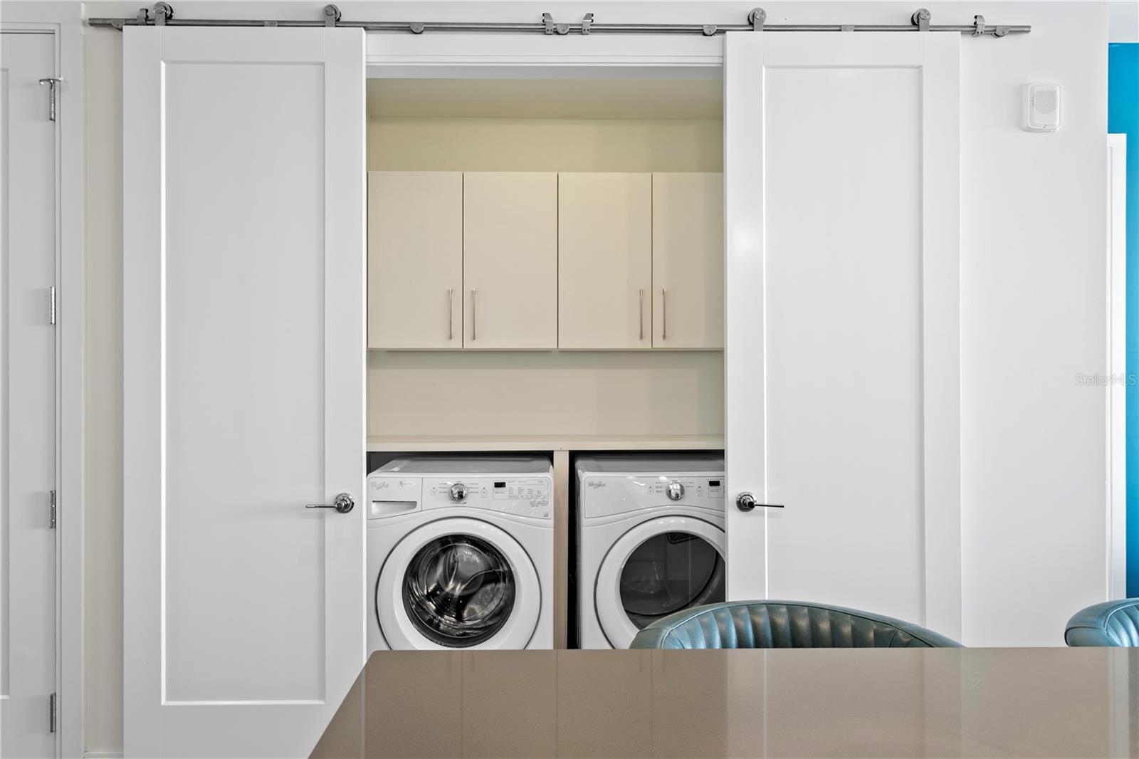 Full size washer/dryer next to kitchen
