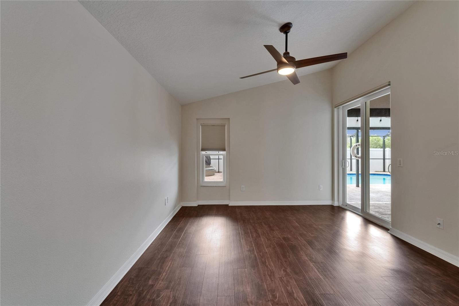 primary bedroom has slider out to covered porch by the pool