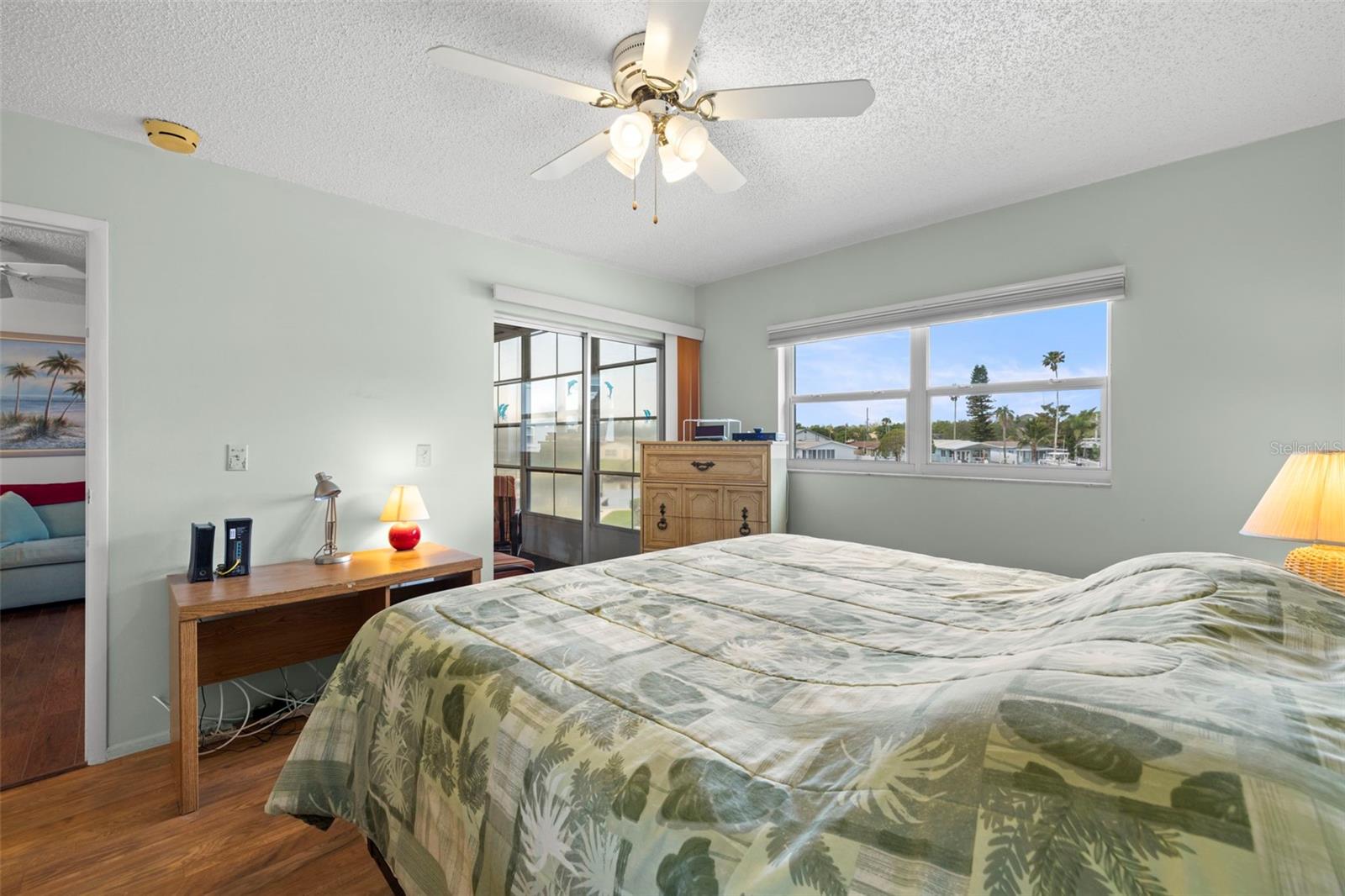 Sliding glass doors from the primary bedroom that has access to the enclosed lanai.