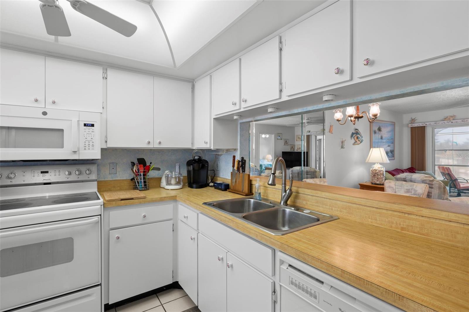 Full kitchen comes equipped with dishwasher, microwave, oven and stainless-steel refrigerator.